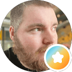 Bearded man looking right in a circular frame with a gradient star badge overlay.